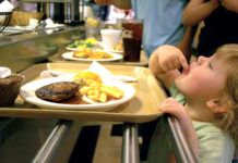 Lundy Grace, 2, sneaks a bite of her french fries in line at Piccadilly Wednesday night.