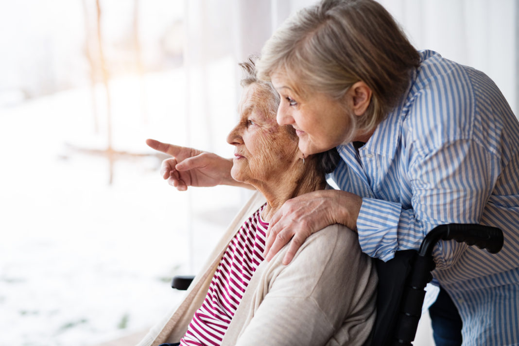 Senior women with wheelchair at home. retirement sandwich generation