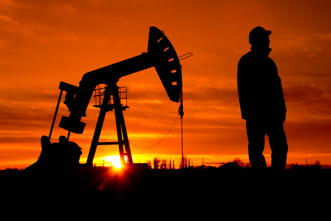 Oil Pumpjack and Worker natural gas