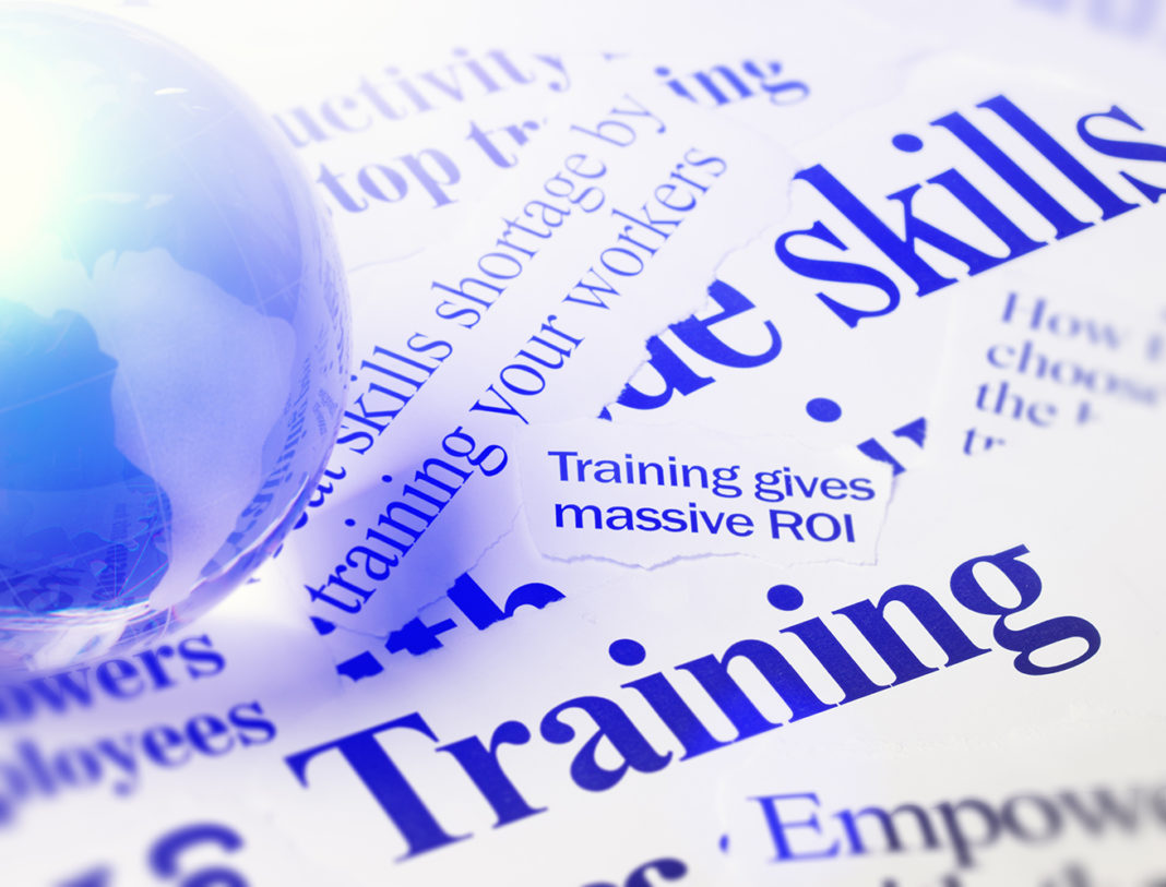 Newspaper headlines on skills and training with glass globe workforce training