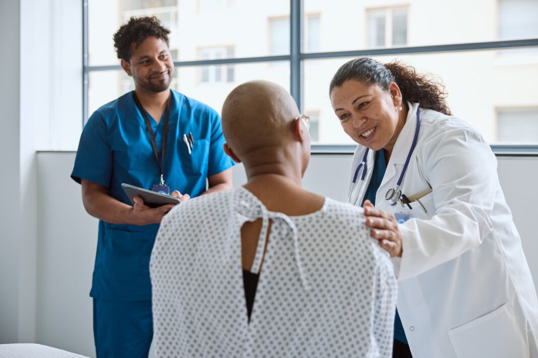 Smiling female doctor encouraging patient in clinic